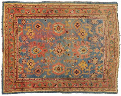 Lot 1136 - Oushak Carpet West Anatolia The pale indigo field with an allover lattice design of large palmettes