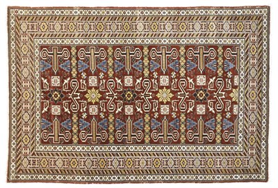 Lot 1138 - A Perepedil Rug East Caucasus The claret field with columns of "ram horn" motifs surrounded by...