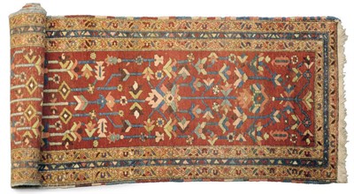 Lot 1142 - A Heriz Runner Persian Azerbaijan The madder field with columns of stylised plants enclosed by...