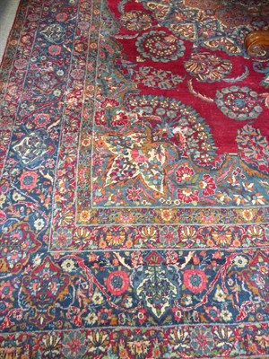 Lot 1147 - Kirman Carpet South East Persia The blood red field centred by a large floral pole medallion...