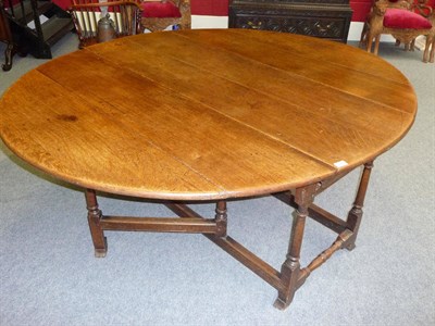 Lot 1149 - An Early 18th Century Oak Gateleg Dining Table, the oval top over a drawer to each end, on...