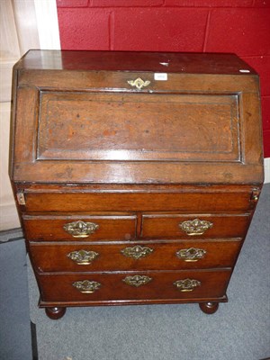 Lot 1151 - A Small Early 18th Century Oak Bureau, the fielded-panel slope enclosing a fitted interior with...