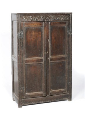 Lot 1163 - An Early 18th Century Joined Oak Cupboard, the rectangular top above a lunette carved frieze...