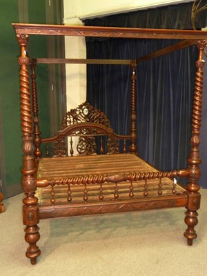 Lot 1193 - An Impressive Colonial Hardwood Four Poster Bed, the headboard with a moulded domed top rail...