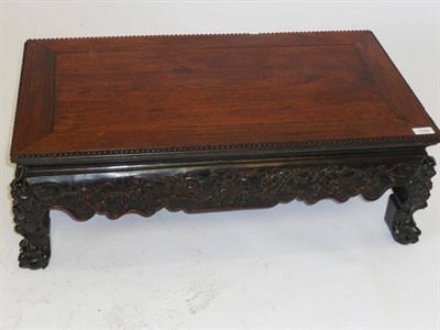 Lot 1194 - A Late 19th Century Chinese Padouk Table Stand, the rectangular top with beaded edge, scrolling...