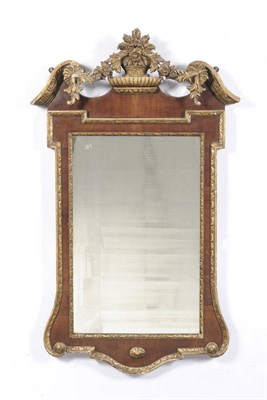 Lot 1218 - A George III Walnut and Parcel Gilt Wall Mirror, the rectangular plate within a leaf carved moulded