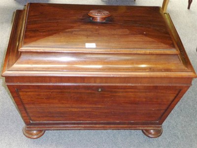 Lot 1233 - A Victorian Mahogany Cellaret, the sarcophagus body with a canted lid enclosing a fitted...