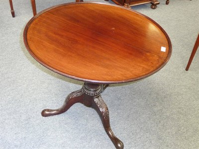 Lot 1241 - A George II Mahogany Tripod Table, the circular dished top on a box birdcage and stop-fluted...