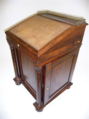 Lot 1255 - A Victorian Rosewood Davenport, the sliding desk with a three-quarter pierced brass gallery above a