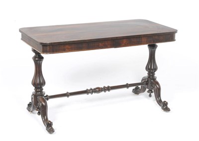 Lot 1265 - A William IV Rosewood Library Table, the rectangular rounded top above a plain frieze, on ring...