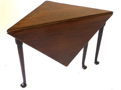 Lot 1268 - A George III Mahogany Triangular Drop-Leaf Table, the top with a single leaf opening square, on...