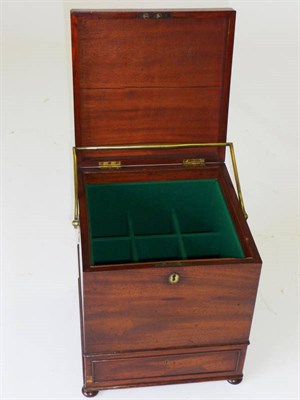 Lot 1269 - A Regency Mahogany Cellaret, the square body with a sham drawer in the base and a large brass swing