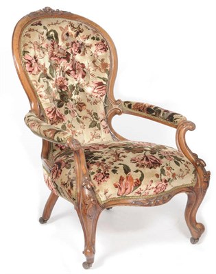 Lot 1282 - A Victorian Walnut-Framed Easy Chair, covered in deep-buttoned floral upholstery, the spoon...