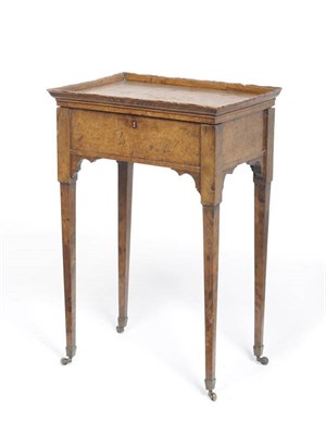 Lot 1292 - A Regency Burr Elm Teapoy, the rectangular top with a wavy rim enclosing four mahogany caddies...