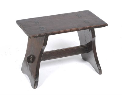 Lot 1298 - A Boarded Hardwood Stool, the rectangular top supported by two shaped ends and joined by a...