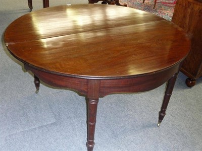 Lot 1303 - A Regency Mahogany Dining Table, of unusual form, the half-round folding top on a shaped frieze and