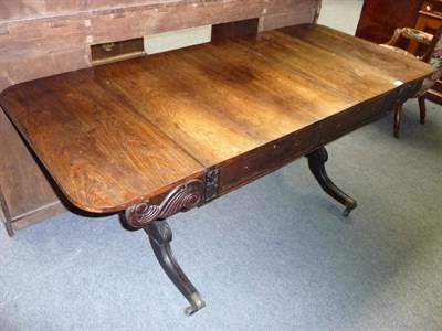 Lot 1304 - A Regency Rosewood Sofa Table, the rectangular top with two rounded drop leaves above two...