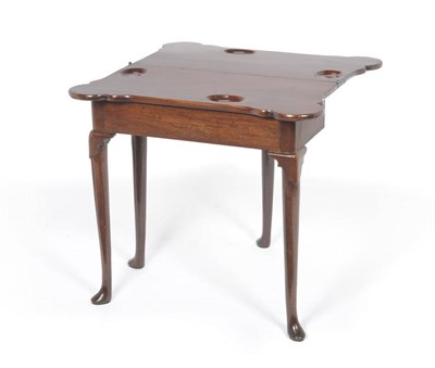 Lot 1307 - A George II Mahogany Foldover Gateleg Table, the rectangular top with eared corners revealing...