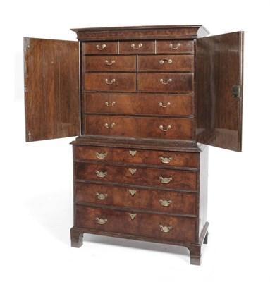 Lot 1319 - A Walnut Cabinet on Chest, Early 18th Century, the projecting cornice over two cupboard doors...