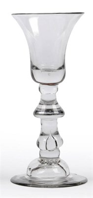Lot 19 - A Wine Glass, circa 1730, the bell bowl with single air bubble in the solid base, upon a drop...