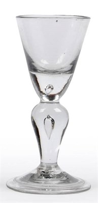 Lot 20 - A Heavy Baluster Wine Glass, circa 1710, the funnel bowl with solid base with tear, on a teared...