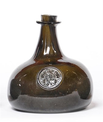 Lot 41 - An English Sealed "Onion" Bottle circa 1710, of dark green metal, the seal of a shield within a...