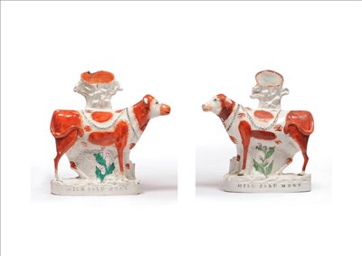 Lot 43 - Two "Milk Sold Here" Staffordshire Pottery Cows, circa 1870, each standing beast on flowering...