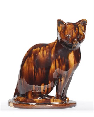 Lot 44 - A Treacle Glaze Model of a Cat, perhaps Canney Hill Pottery, Bishop Auckland, circa 1870, seated on