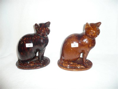Lot 45 - A Treacle Glaze Model of a Cat, perhaps Canney Hill Pottery, Bishop Auckland, circa 1870, seated on
