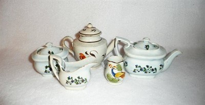 Lot 95 - An English Pearlware Pottery Miniature Teaset, circa 1830, each piece of cushion form, painted with