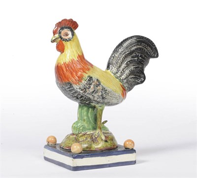 Lot 106 - An English Pearlware Pottery Model of a Cockerel, circa 1800, standing with orange, yellow and...