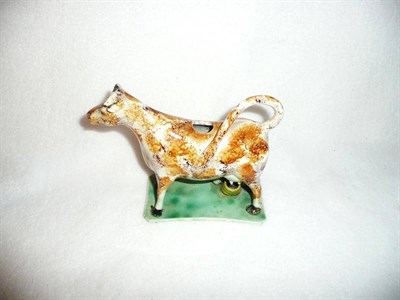 Lot 107 - A Prattware Cow Creamer, circa 1810, the standing beast attended by a small milkmaid with black...