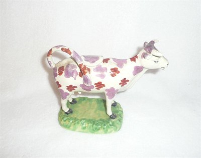 Lot 114 - An English Pearlware Pottery Cow Creamer, early 19th century, typically modelled with red and...