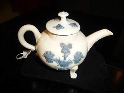 Lot 123 - A Saltglazed Teapot and Cover, circa 1750, of compressed globular form, sprigged in blue...