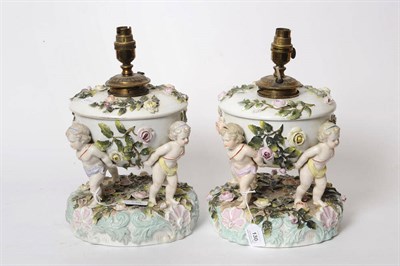 Lot 130 - A Pair of German Encrusted Porcelain Figural Oil Lamps, circa 1890, the rose encrusted domed...