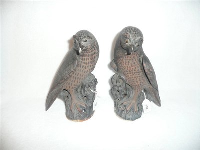 Lot 152 - A Pair of Chinese Stoneware Models of Hawks, 19th century, each perched on a pierced and rocky...