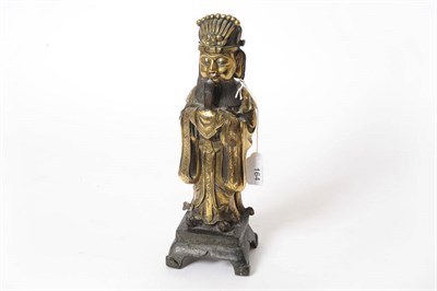 Lot 164 - A Chinese Gilt Bronze Figure of a Scholar, perhaps 17th/18th century, standing holding a ruyi...