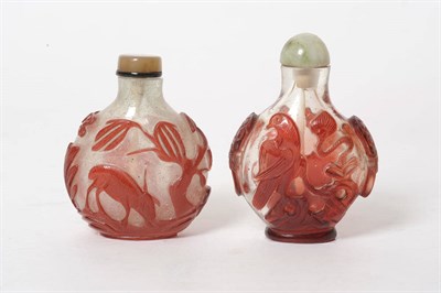 Lot 171 - A Red Overlay Glass Snuff Bottle, circa 1850-1900, boldly carved on one side with a dog tethered to