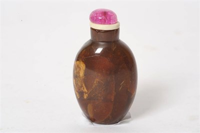 Lot 172 - An Amber Snuff Bottle, of flattened ovoid plain form, pink tinted quartz type stopper, 7cm overall