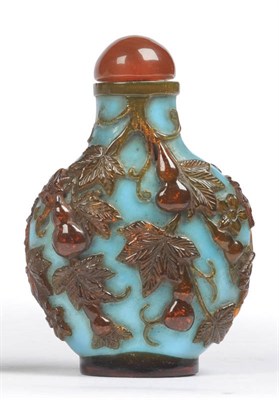 Lot 195 - An Amber and Turquoise Overlay Glass Snuff Bottle, late 19th century, of flattened spherical...