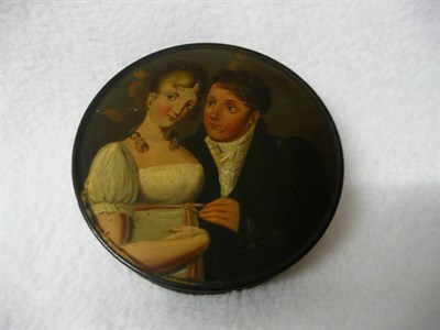 Lot 312 - A Painted Black Lacquered Papier Mache Snuff Box, circa 1830, circular and concave sided, the...