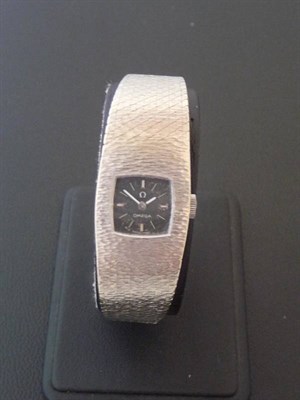 Lot 352 - A Lady's 18ct White Gold Wristwatch, signed Omega, circa 1970, 17-jewel lever movement, black...