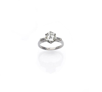 Lot 442 - A Diamond Solitaire Ring, the round brilliant cut diamond in a white six claw setting is flanked by