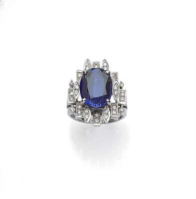 Lot 446 - A Synthetic Sapphire and Diamond Fancy Cluster Ring, the step cut sapphire within a diamond set...