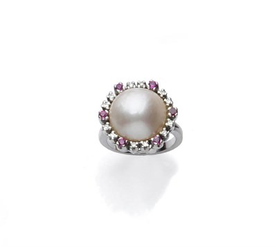 Lot 449 - A Mabe Pearl, Diamond and Ruby Ring, the mabe pearl within a border of eight-cut diamonds, with...