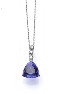 Lot 451 - An 18 Carat White Gold Tanzanite and Diamond Pendant on Chain, three round brilliant cut...