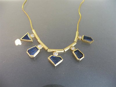 Lot 454 - A Sapphire and Diamond Necklace, the various shaped step cut sapphires in rubover settings are...