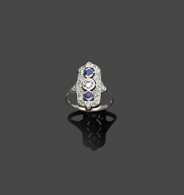 Lot 457 - An Art Deco Diamond and Sapphire Ring, the round brilliant cut diamond set between two...