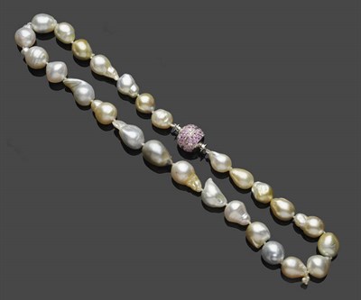 Lot 460 - A Cultured Baroque Pearl Necklace with Pink Sapphire and Diamond Set Clasp, the irregularly...