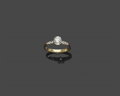 Lot 462 - An Edwardian Diamond Solitaire Ring, the old cut diamond in a white six claw setting, between...